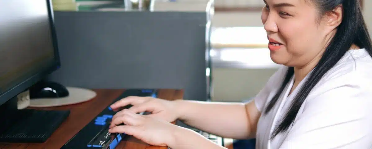 Woman with disabilities uses a special assistive technology computer in the home