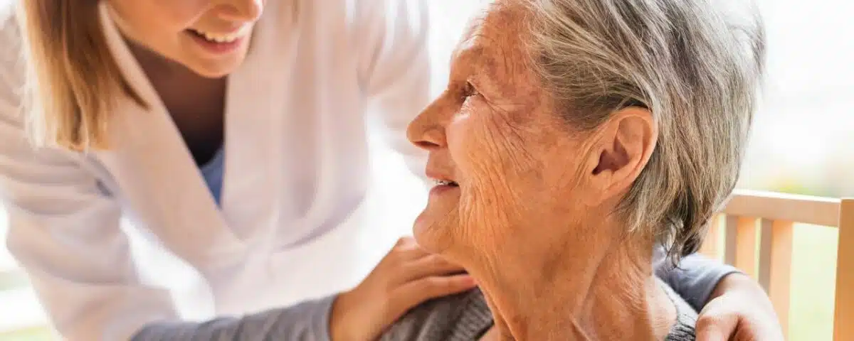 Personalized service ion the home for the elderly or disabled - nurse comforts older woman in her own home