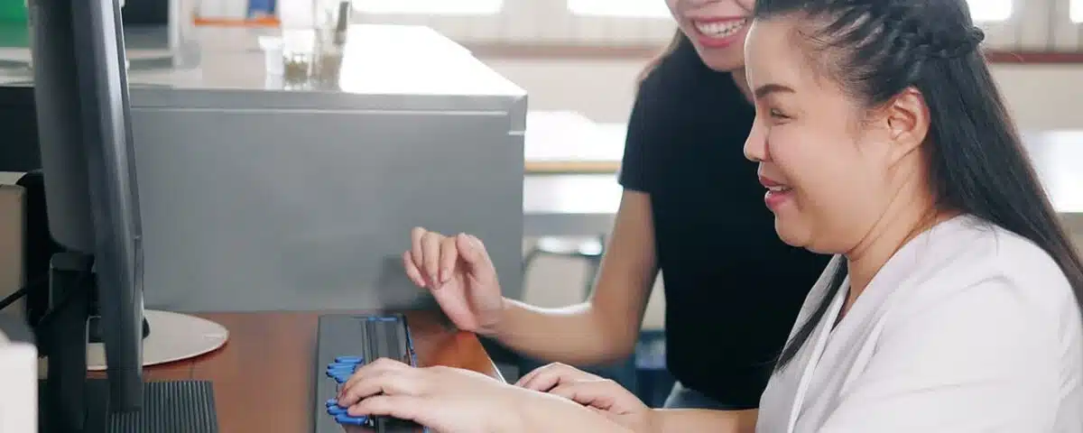 Woman with disabilities using an Assistive Technology keyword on her computer